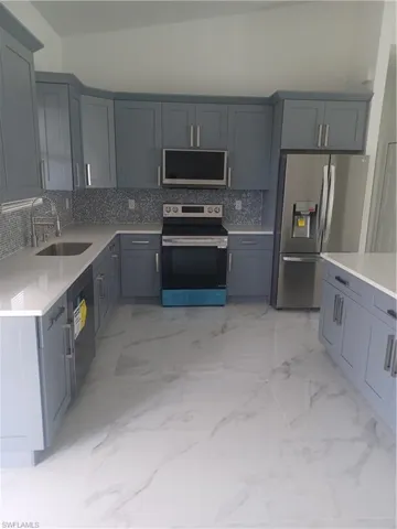 Kitchen featuring decorative backsplash, refrigerator, sink, electric stove, and dishwasher