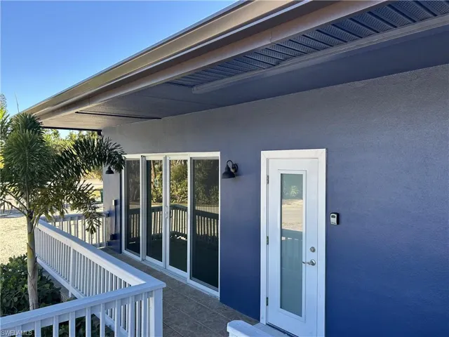 Doorway to property with stucco siding