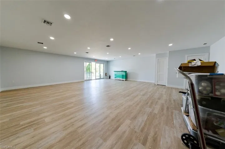 Living room featuring recessed lighting and light wood-style flooring