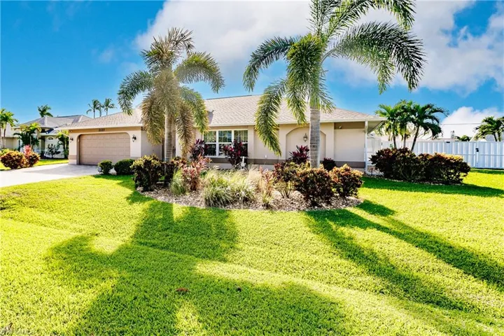 Ranch-style home with a front yard and a garage