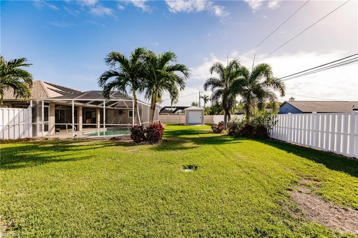View of yard with a lanai and a fenced in pool