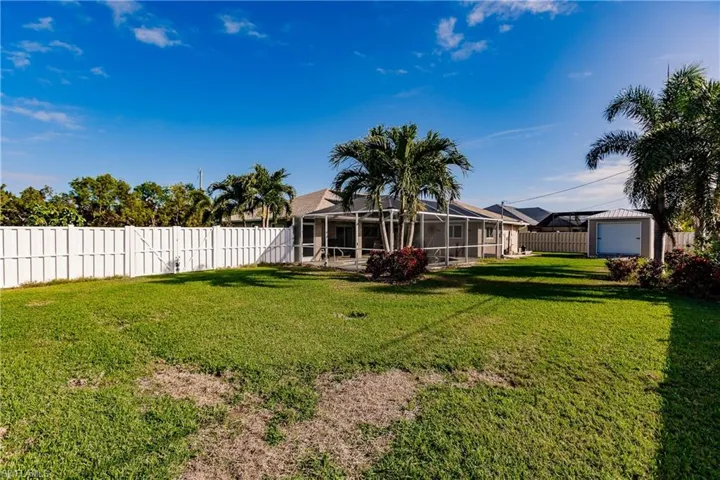 View of yard with an outbuilding and a lanai