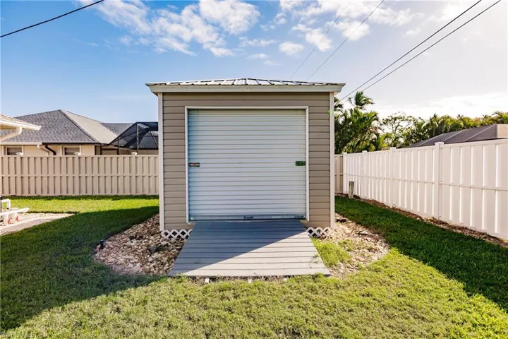 View of outbuilding with a yard