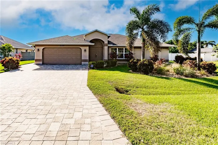 Ranch-style house with a garage and a front yard