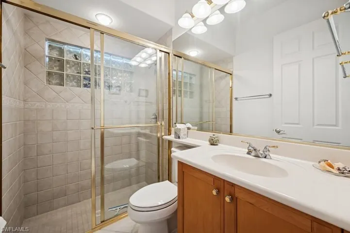 Full bath featuring vanity and a shower stall