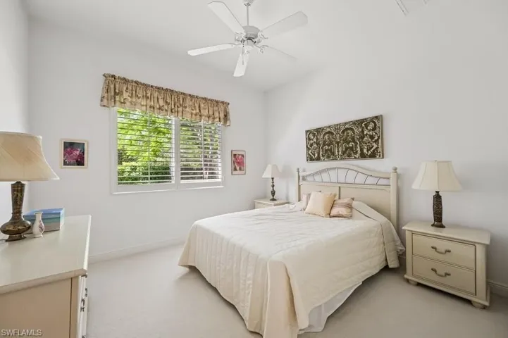 Bedroom with light colored carpet and ceiling fan