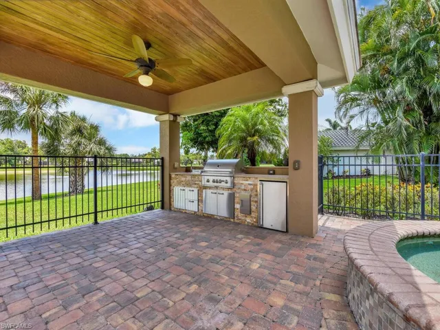 View of patio / terrace with a water view, a ceiling fan, and a sink