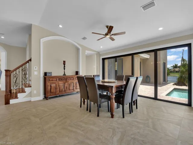 Dining room with a ceiling fan, recessed lighting, arched walkways, ornamental molding, and stairway