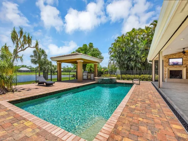 View of swimming pool with a patio, a pool with connected hot tub, ceiling fan, and a gazebo