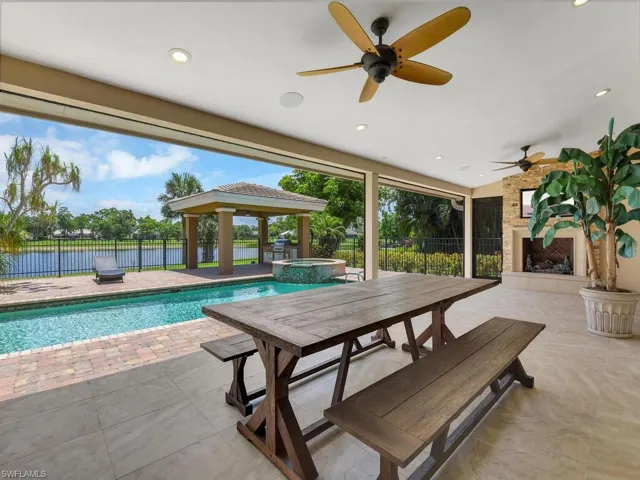 View of swimming pool with a patio, a gazebo, ceiling fan, and a fireplace
