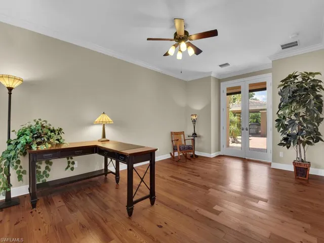 Office area featuring french doors, ceiling fan, wood finished floors, baseboards, and crown molding