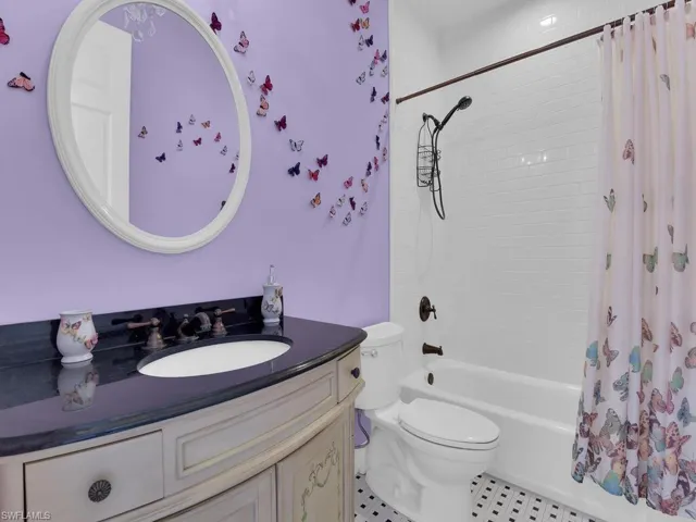 Full bath with vanity, shower / bath combination with curtain, toilet, and tile patterned flooring