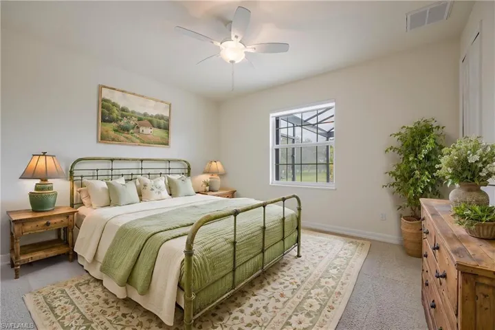 Bedroom featuring ceiling fan and light carpet