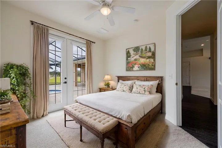 Carpeted bedroom featuring ceiling fan, access to outside, and french doors