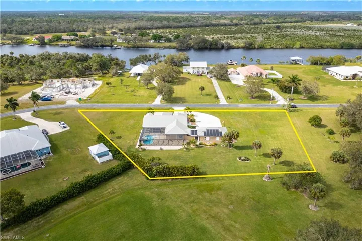 Birds eye view of property with a water view