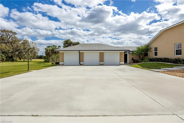 View of home's exterior featuring a yard and a garage