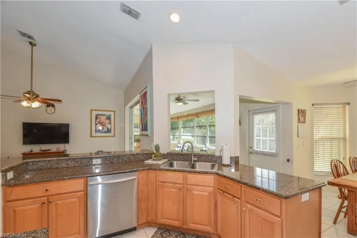 Updated Kitchen with Granite countertops, glass backsplash, stainless steel appliances