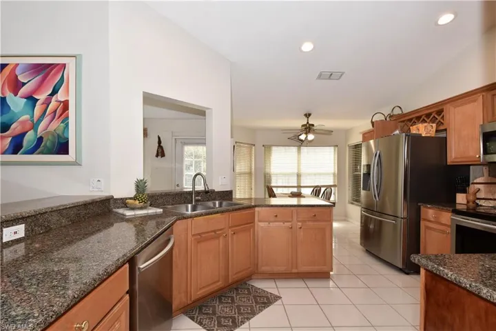 Updated Kitchen with Granite countertops, glass backsplash, stainless steel appliances