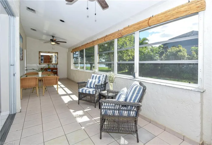Florida room featuring ceiling fans and vaulted ceiling. You have a view of the lake.