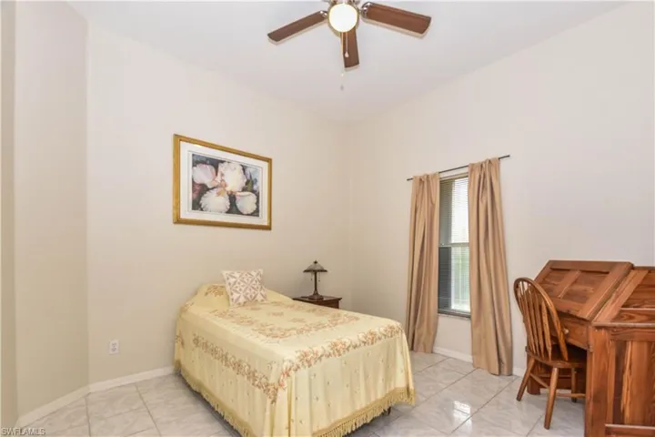 Bedroom featuring light tile patterned flooring and ceiling fan