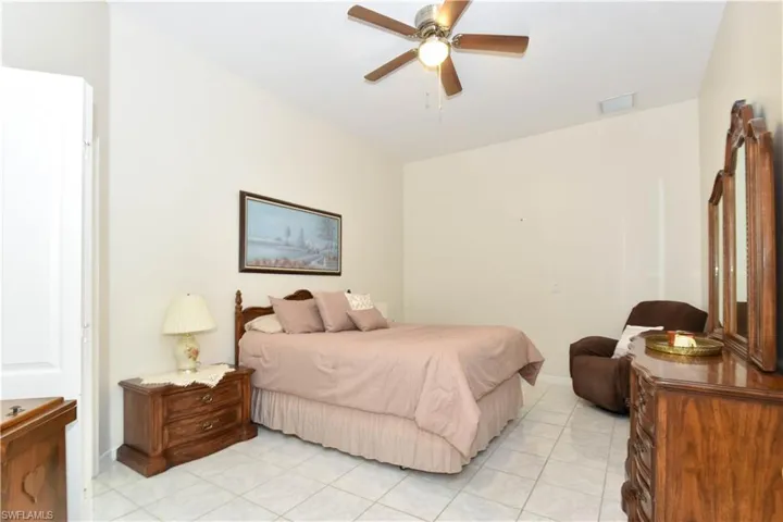 Tiled bedroom with ceiling fan