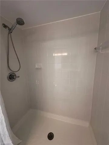 Full bathroom featuring tiled shower