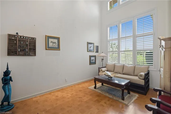 Living room with a high ceiling and wood finished floors