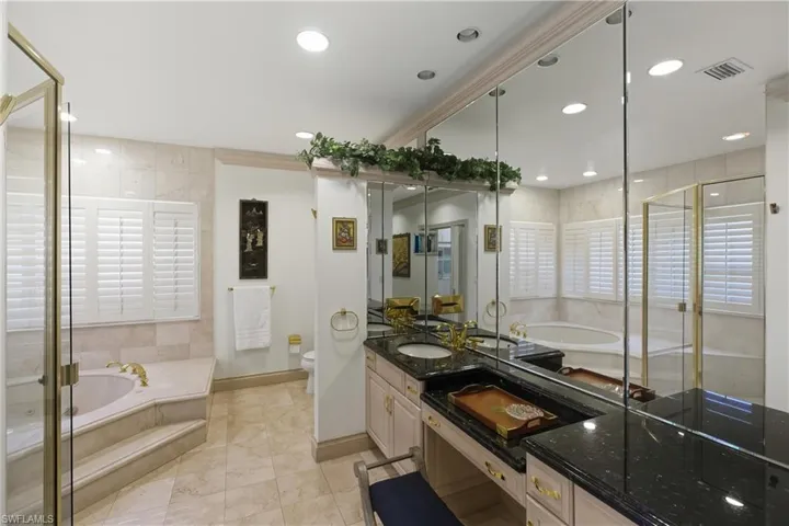 Bathroom featuring a garden tub, vanity, a stall shower, recessed lighting, and light tile patterned floors