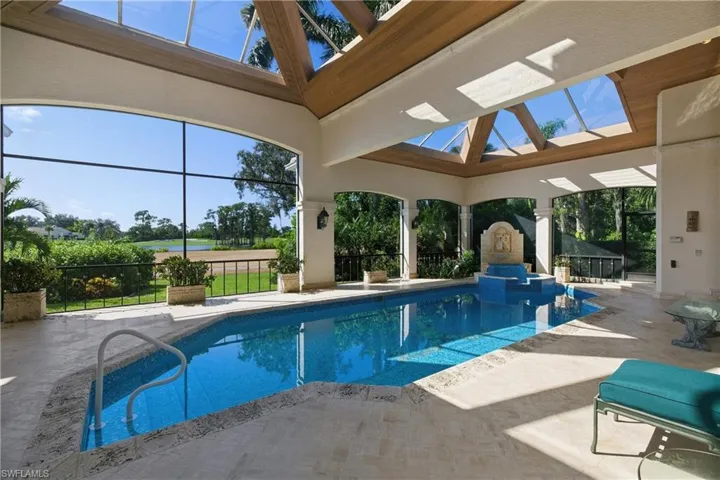 View of swimming pool with a pool with connected hot tub, a patio area, a lanai, and a sunroom