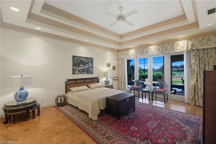 Bedroom with a tray ceiling, ornamental molding, access to exterior, recessed lighting, and a ceiling fan