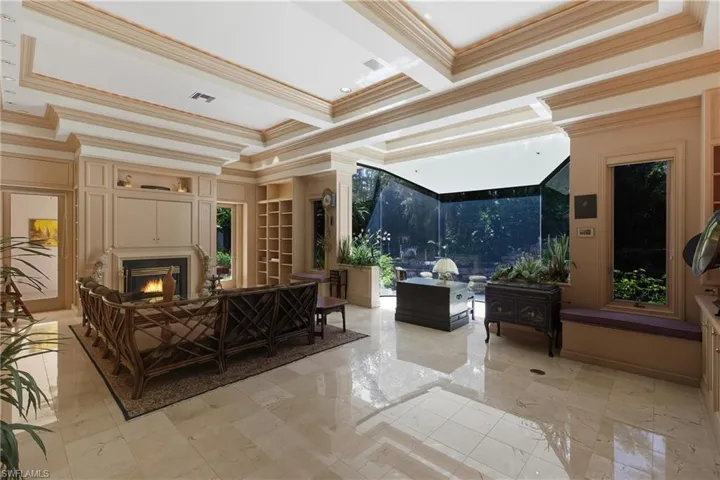 Lobby featuring crown molding, coffered ceiling, and beamed ceiling