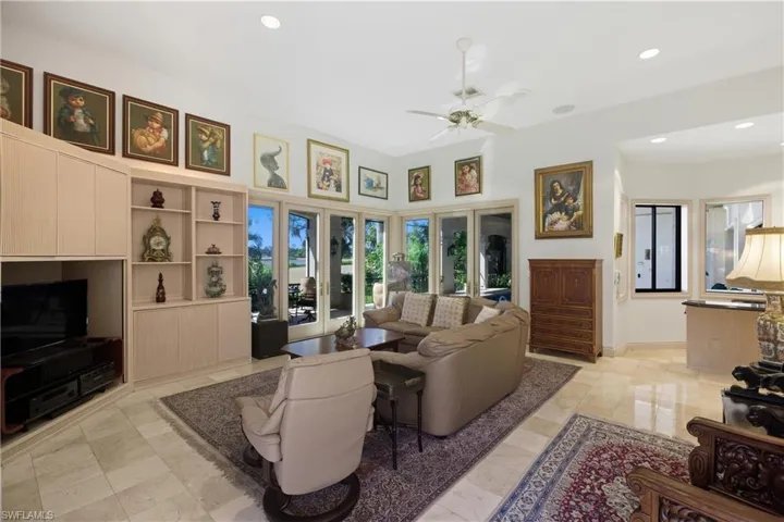Living room with ceiling fan and recessed lighting