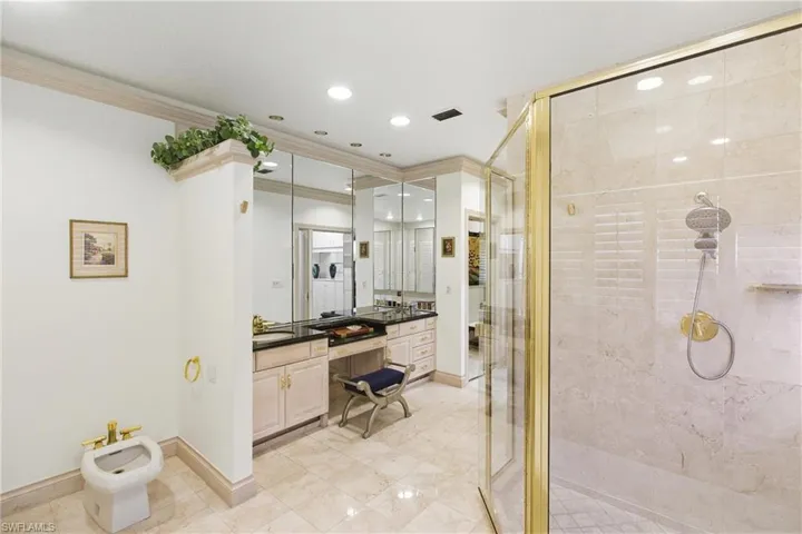 Full bathroom featuring vanity, a shower stall, ornamental molding, a bidet, and recessed lighting