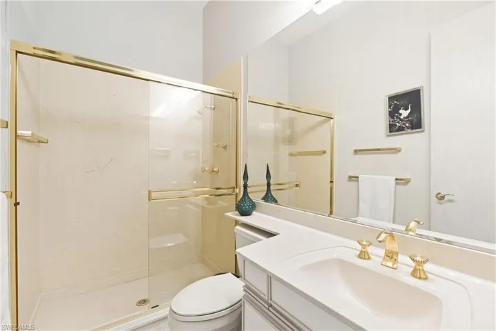 Full bath featuring vanity and a shower stall