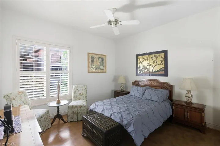 Bedroom featuring ceiling fan and baseboards