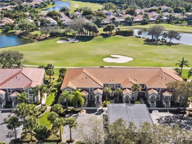 Birds eye view of property with a water view