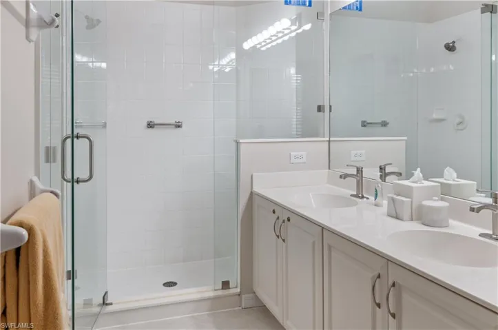 Bathroom with vanity and a shower with shower door