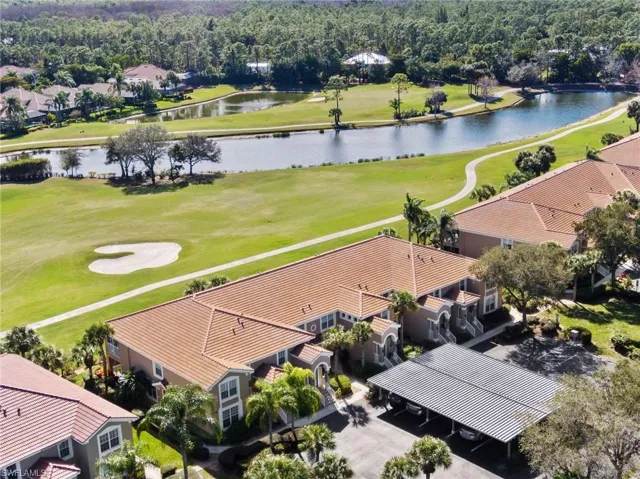 Birds eye view of property with a water view