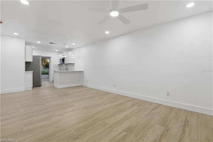 Unfurnished living room with recessed lighting, ceiling fan, and light wood-type flooring