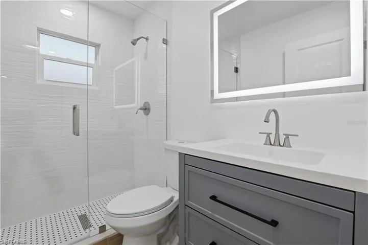 Full bath with vanity and a shower stall