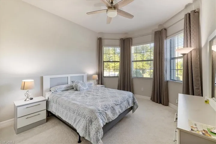 Bedroom with light colored carpet and ceiling fan