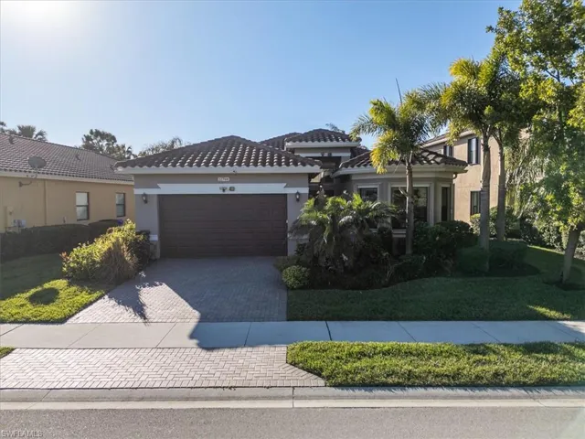 View of front of house with a garage and a front lawn
