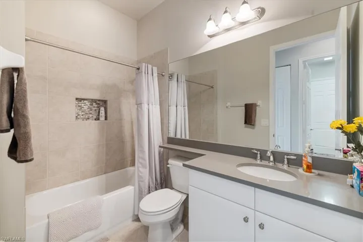 Full bathroom with vanity, toilet, and shower / bath combo
