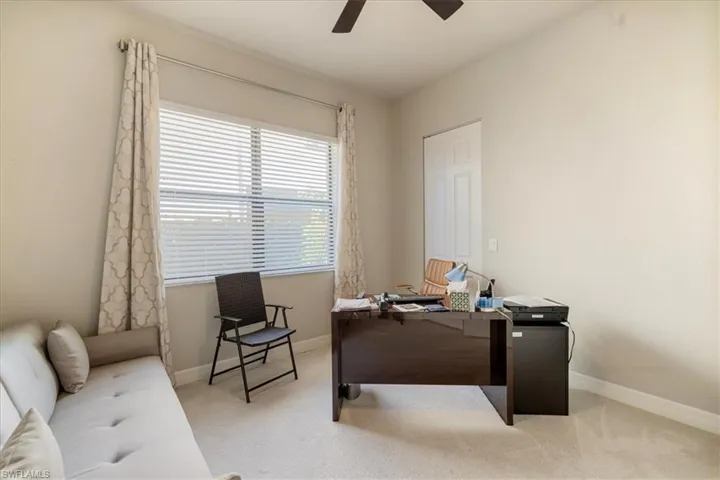 Carpeted office space with ceiling fan