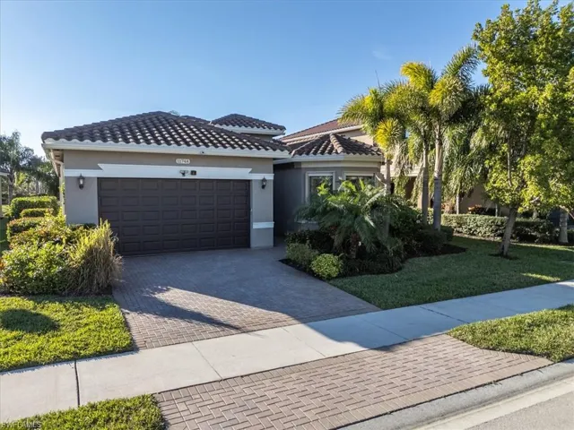 View of front of property featuring a garage and a front yard