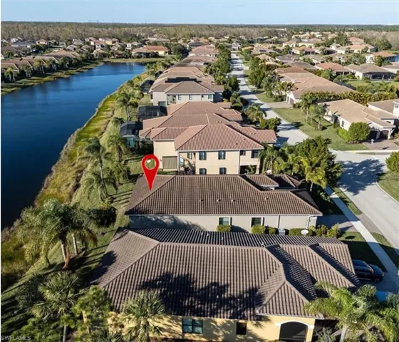 Birds eye view of property with a water view