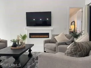 Living area featuring a glass covered fireplace
