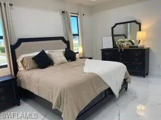 Bedroom with light marble finish floors
