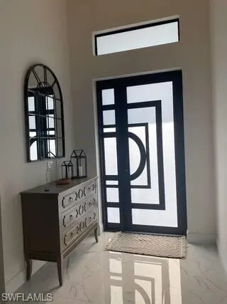 Entrance foyer with marble finish floors and healthy amount of natural light