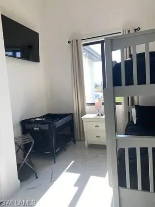 Bedroom with light marble finish floors